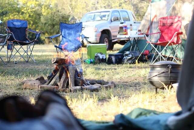 Family campsite around an open fire pit